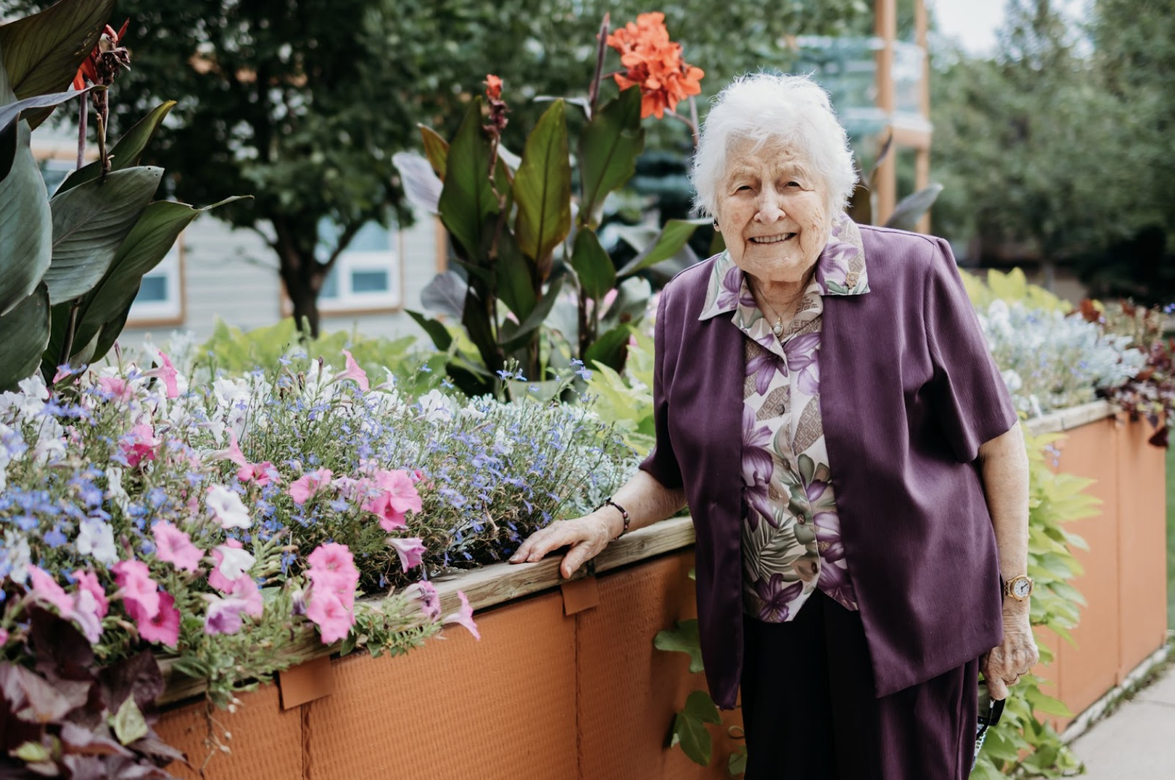 senior woman standing by a garden